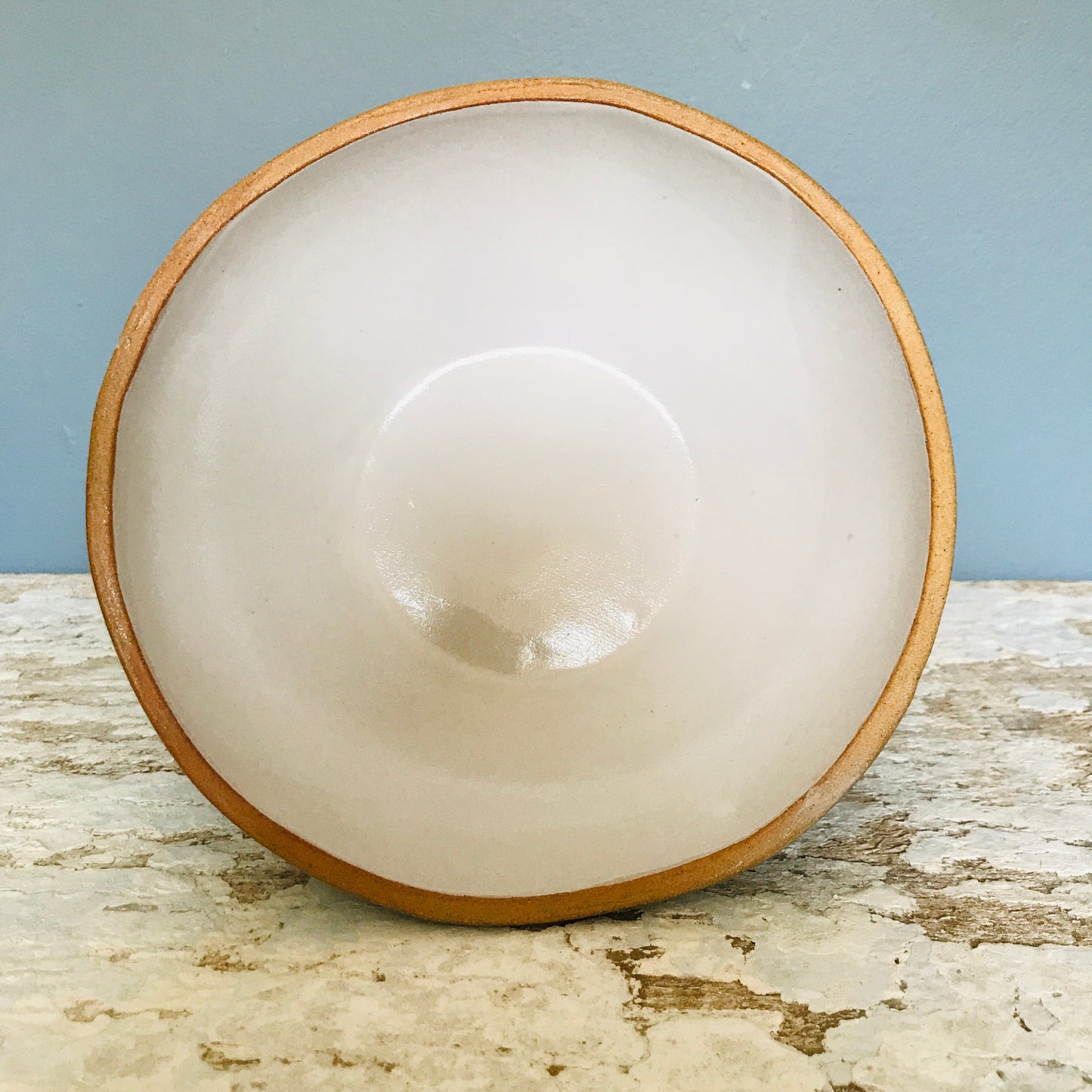 Natural stoneware glazed ceramic raised bowl with speckled glaze