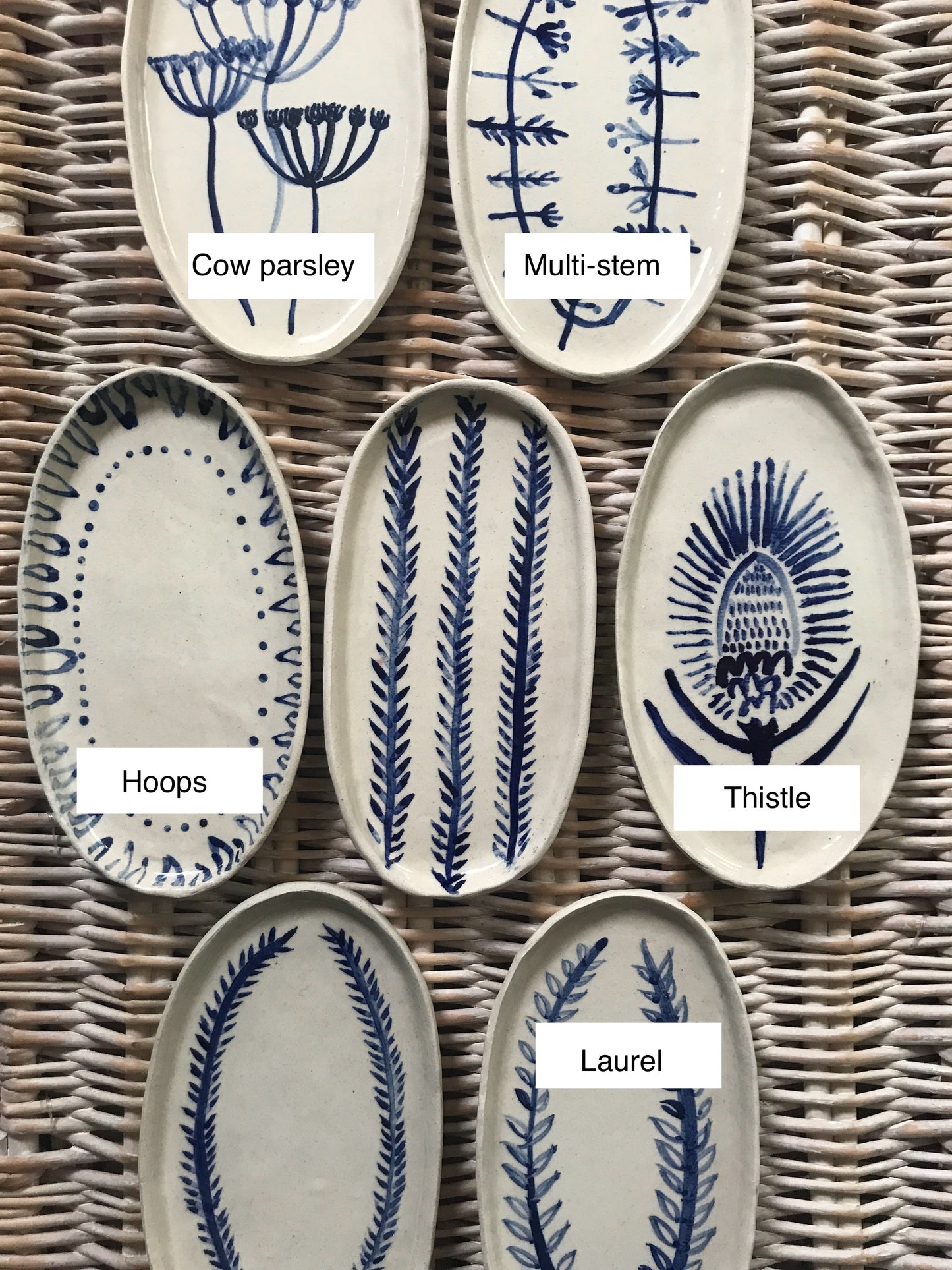 Natural stoneware glazed ceramic oval side plate with hand painted blue leaf garland floral design