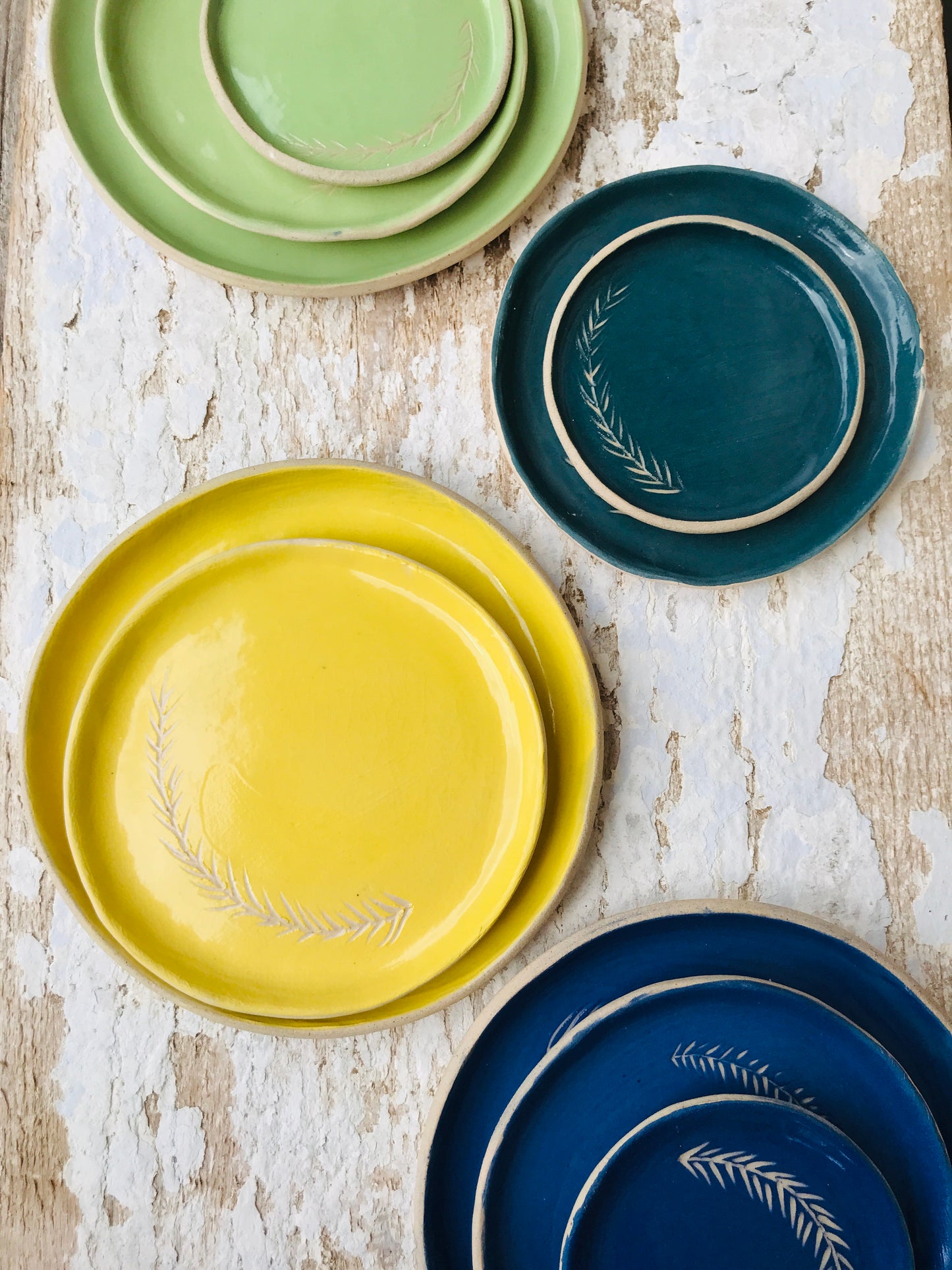 Botanical brights sgraffito ceramic side dish sets in Kingfisher blue, Parakeet green, Goldfinch yellow, Woodpecker teal.