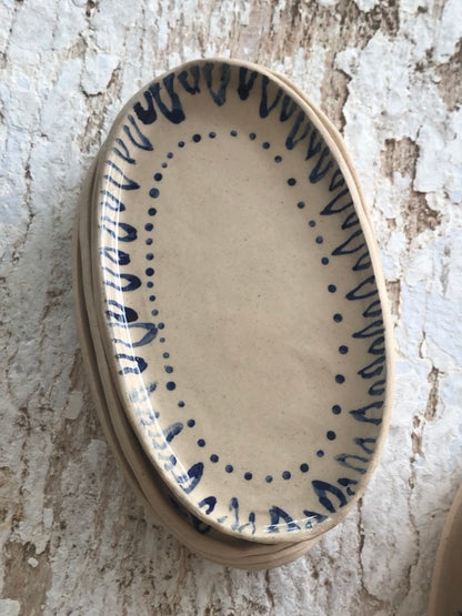 Natural stoneware glazed ceramic oval side plate with hand painted blue leaf garland floral design