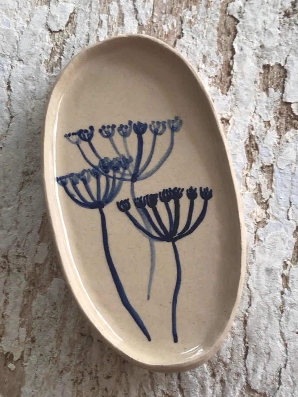 Natural stoneware glazed ceramic oval side plate with hand painted blue leaf garland floral design