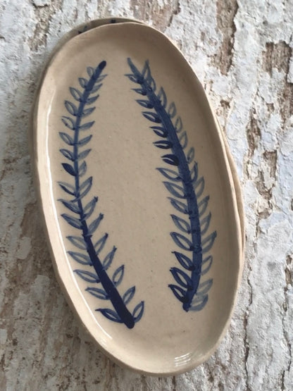 Natural stoneware glazed ceramic oval side plate with hand painted blue leaf garland floral design