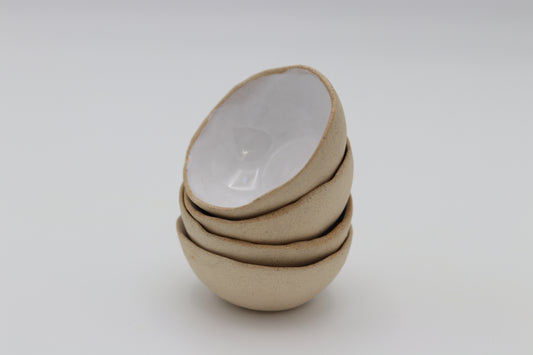 a stack of white glazed ceramic stacking mini bowls 