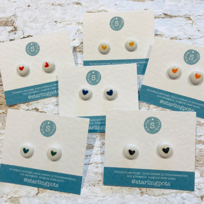 Round shaped, heart painted porcelain hypo-allergenic stud earrings