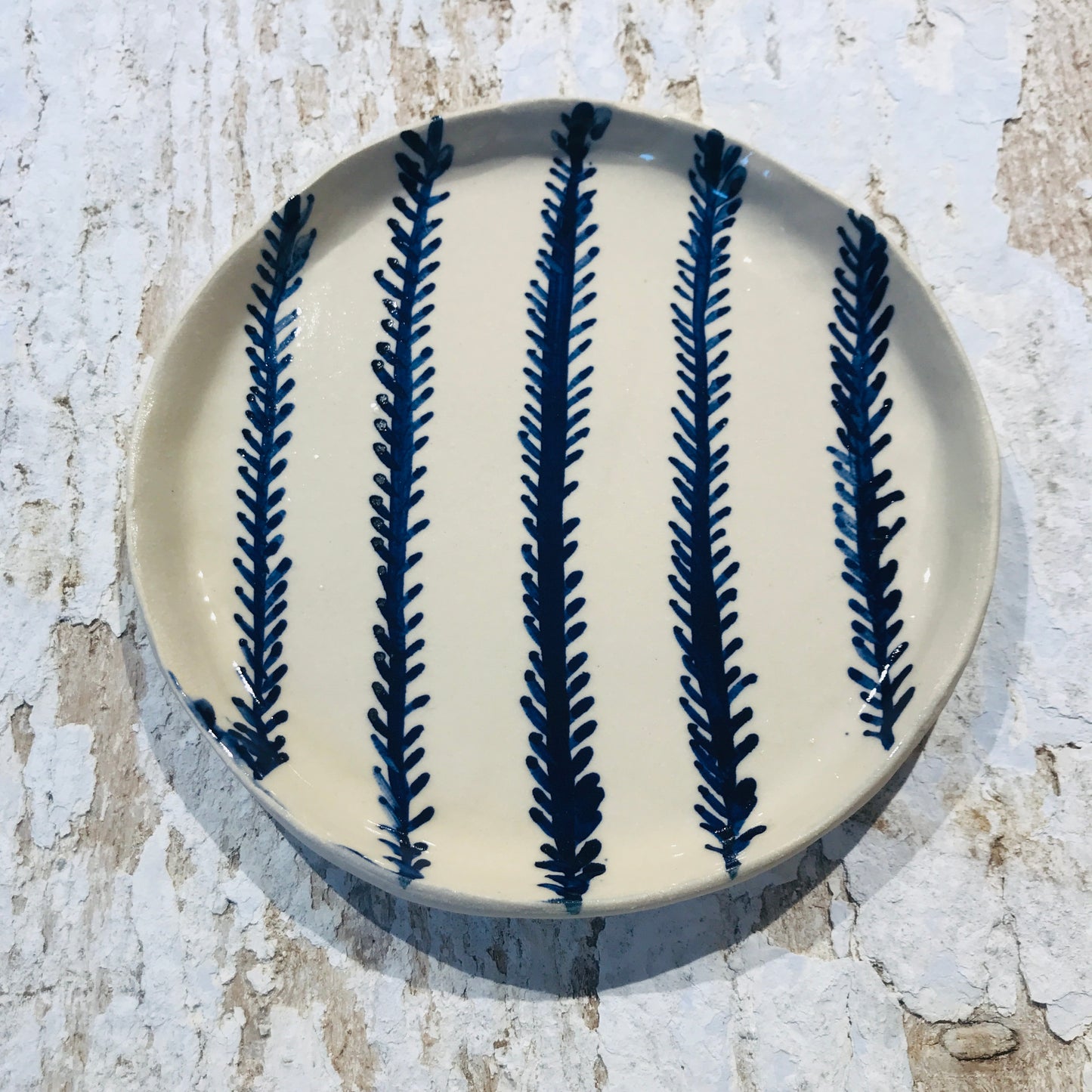 Natural stoneware glazed ceramic plate with hand painted blue leaf garland floral design