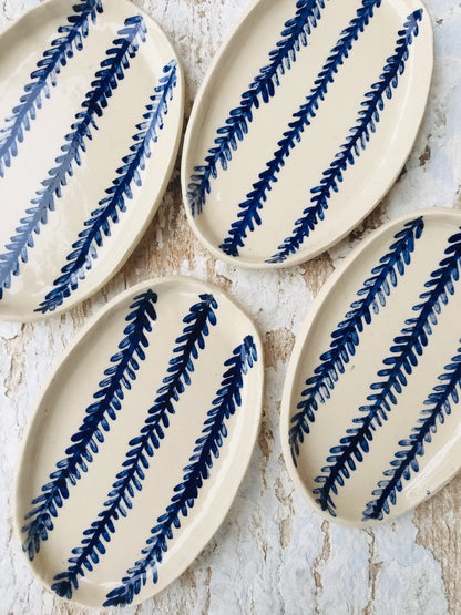 Natural stoneware glazed ceramic oval side plate with hand painted blue leaf garland floral design