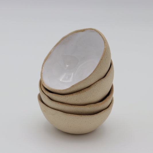 a stack of white glazed ceramic stacking mini bowls 
